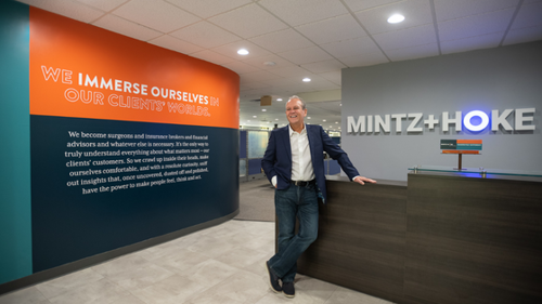Ron Perine standing at the Front Desk at the Mintz + Hoke office